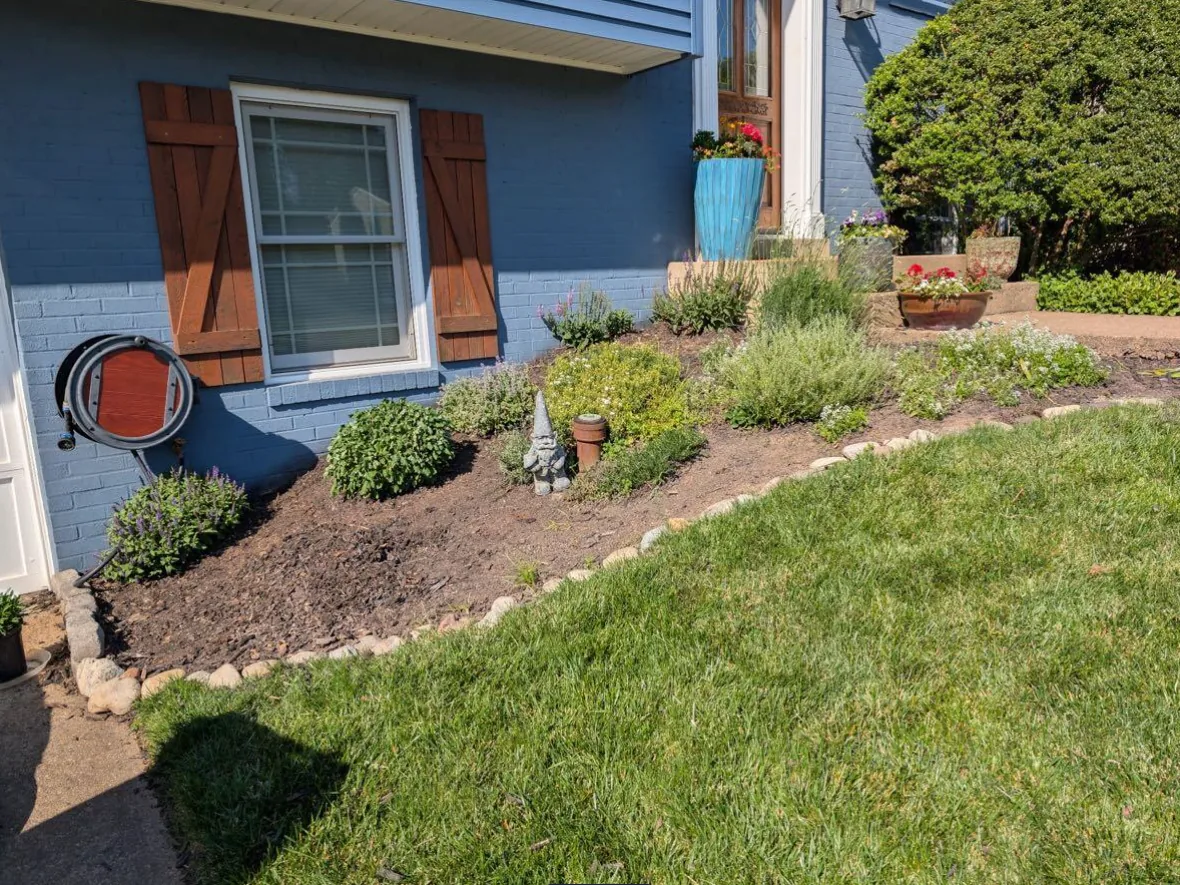 Front garden bed cleaned up and edged with river stone